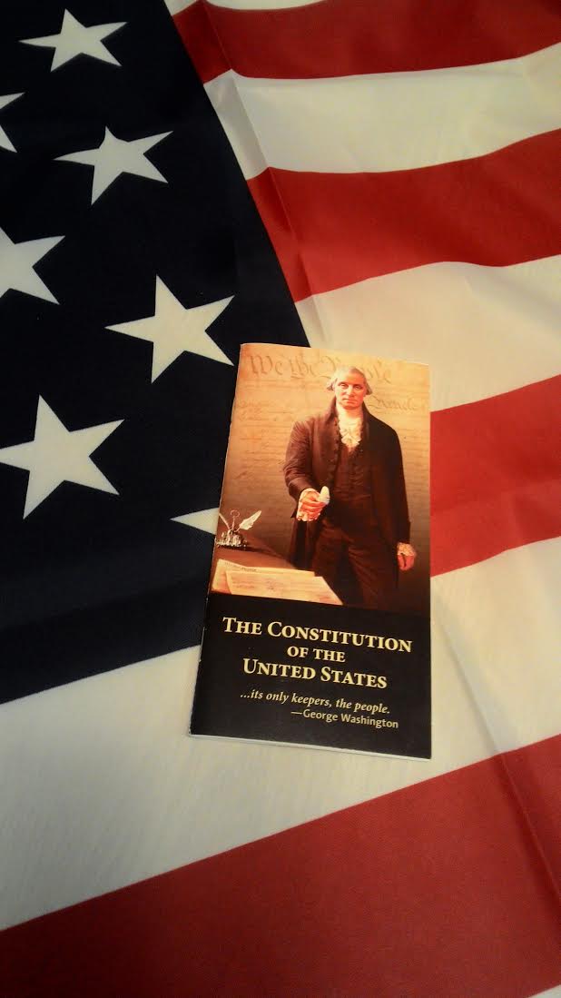 USA flag with a booklet of the Constitution of the United States